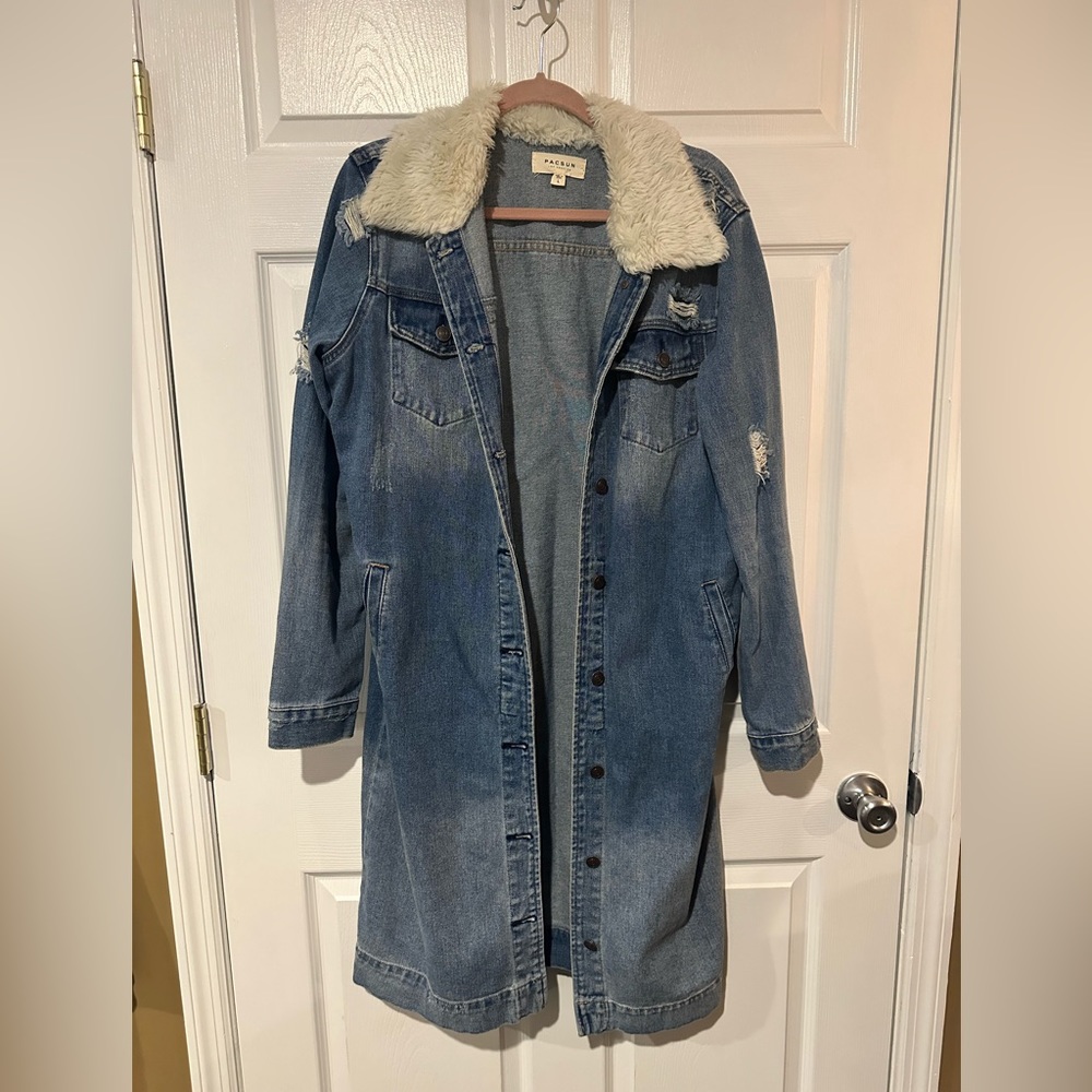 Calf length distressed denim jacket with faux fur collar.